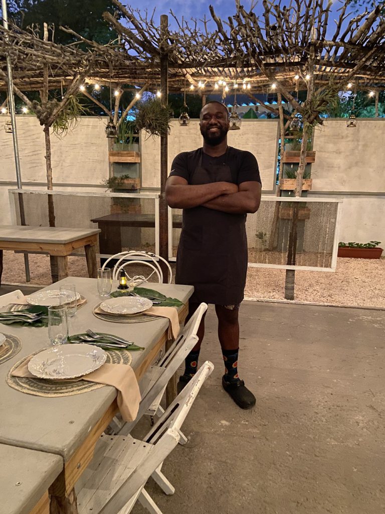 Kris Kierindongo serving dinner on his former basketball court