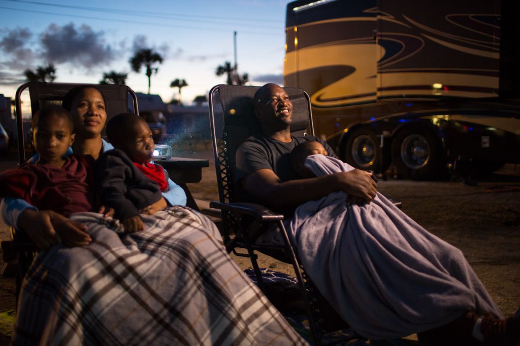 Family relaxing by their motorhome.