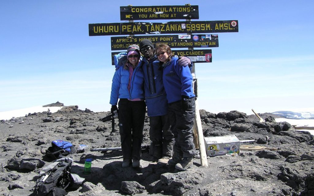 Reggie-on-left-at-the-summit-of-Kilimanjaro.-Eileen-didnt-quite-make-it-to-the-top-1080x675