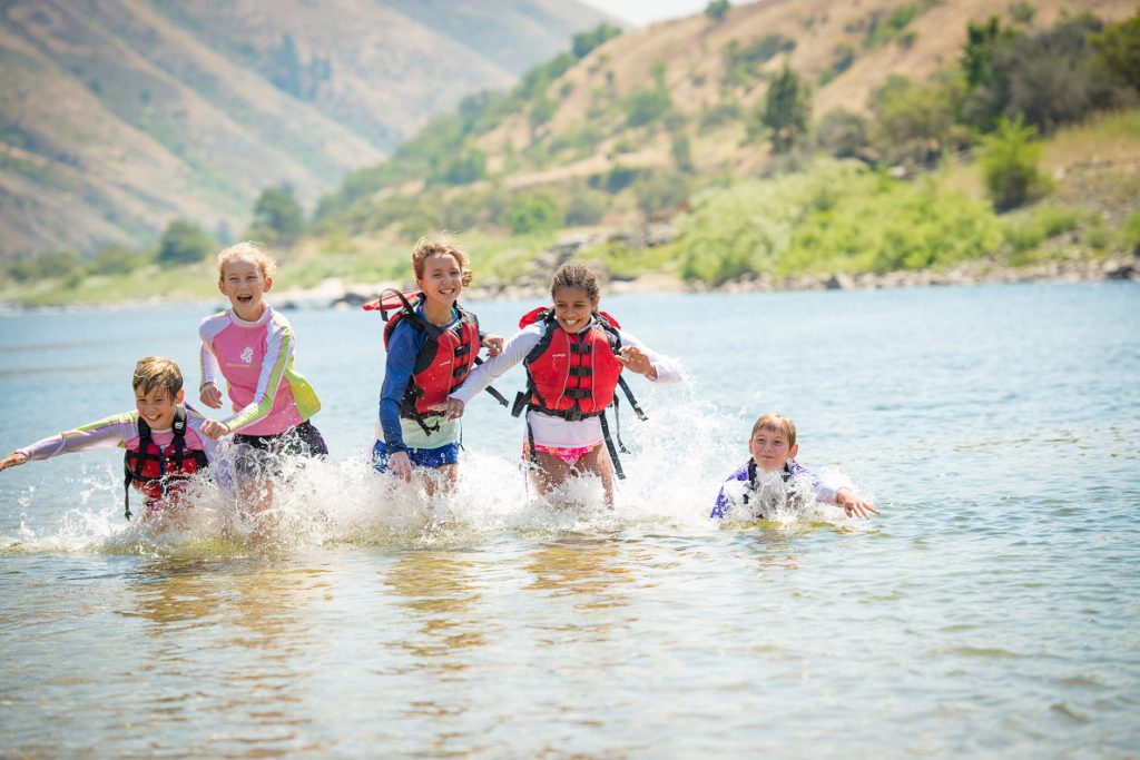 Kids splashing in the Salmon River on ROW Adventures raft trip