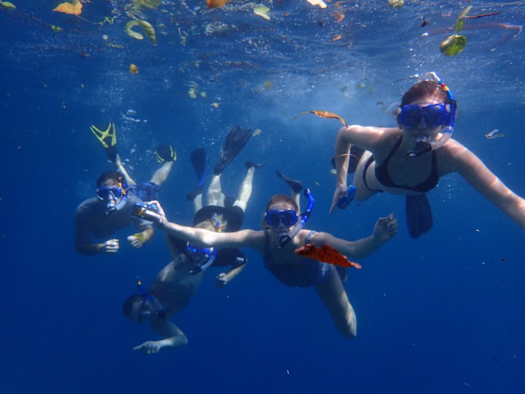 Family snorkeling together in Hawaii