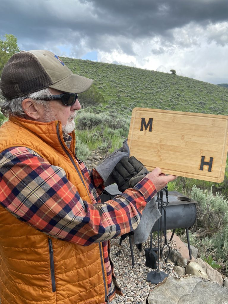 Branding a cutting board at the Collective Retreats glamping site near Vail