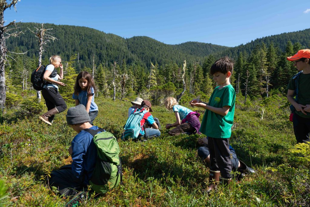 Kids picking wild berries on an UnCruise in Alaska