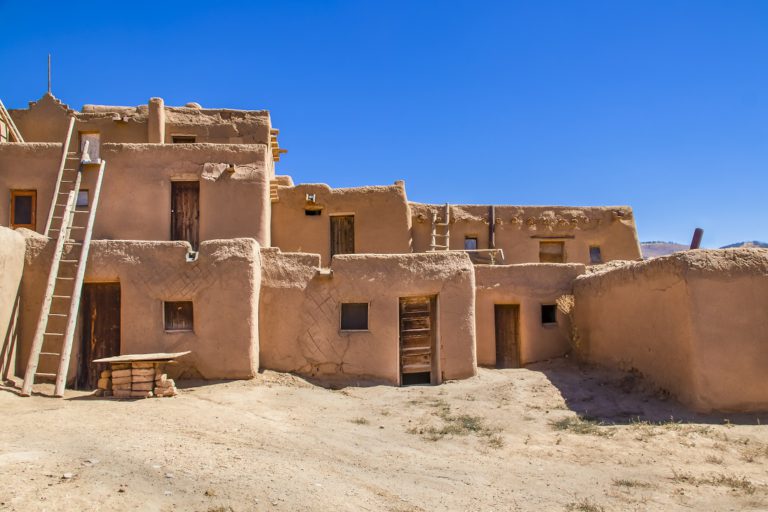 Multi-story adobe buildings from Taos Pueblo in New Mexico where Indigenous people are still living after over a thousand years.
