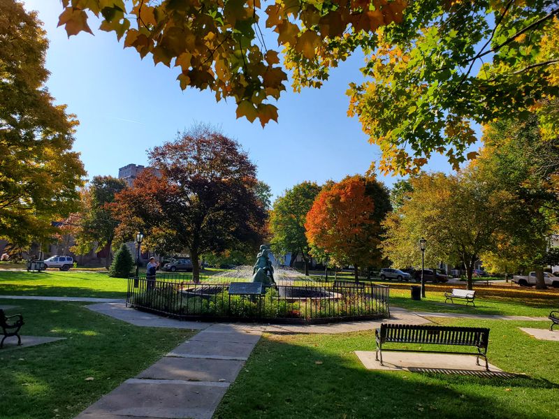 The Town Square Green Provides A Gathering Space For Relaxation And Community Events