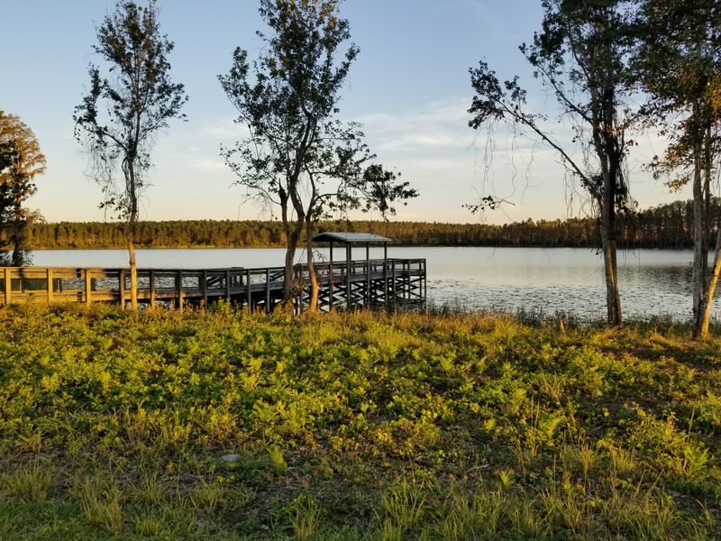 Kayaking And Paddleboarding On Glassy Morning Water