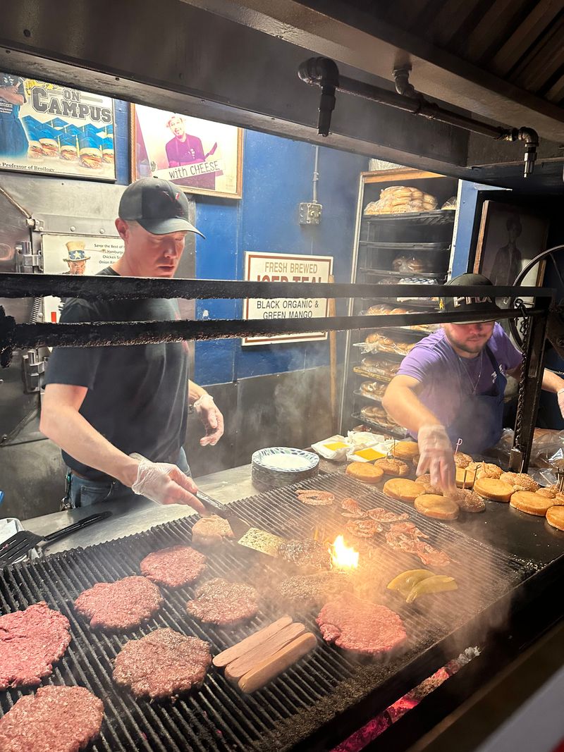Burgers Are Cooked Over An Open Mesquite Charcoal Grill