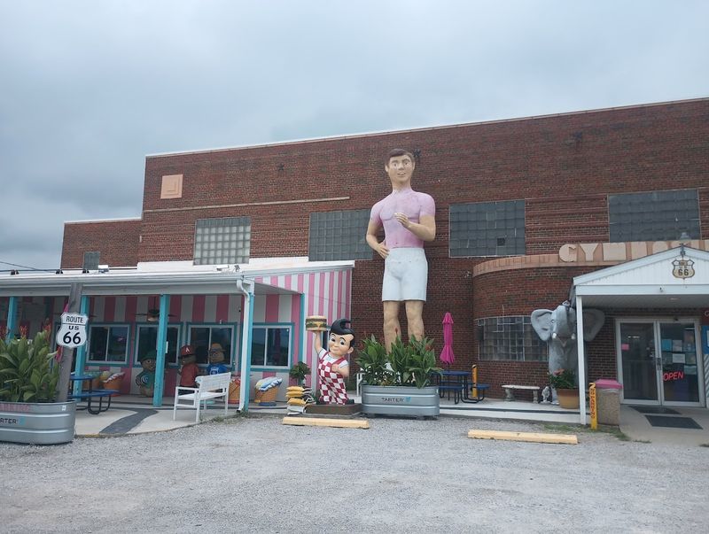 The Elephant Stands Beside A Busy Gas Station In DeForest