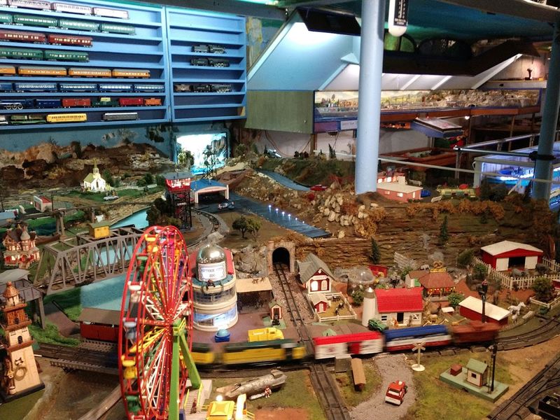 Model Trains Run Through Detailed Miniature Landscapes