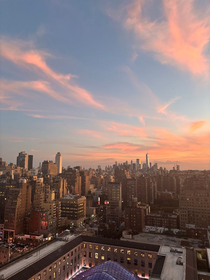 Sunset From A Rooftop With Skyline Views