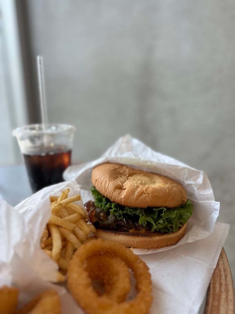 Fresh Ground Beef Patties Cooked On A Sizzling Flat-Top Grill