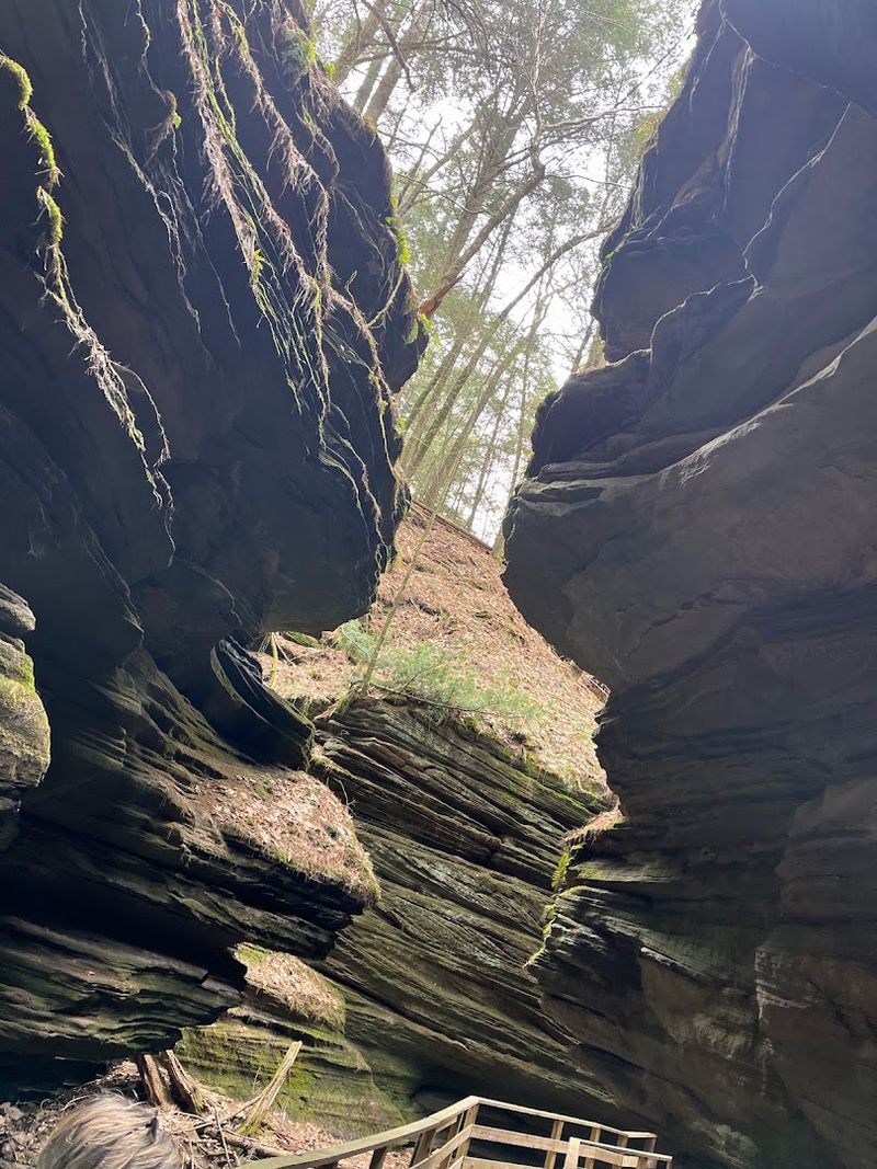Towering Rock Walls Rise High Above The Path