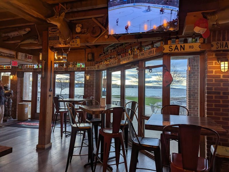 A Dining Room With Large Windows Facing The Water