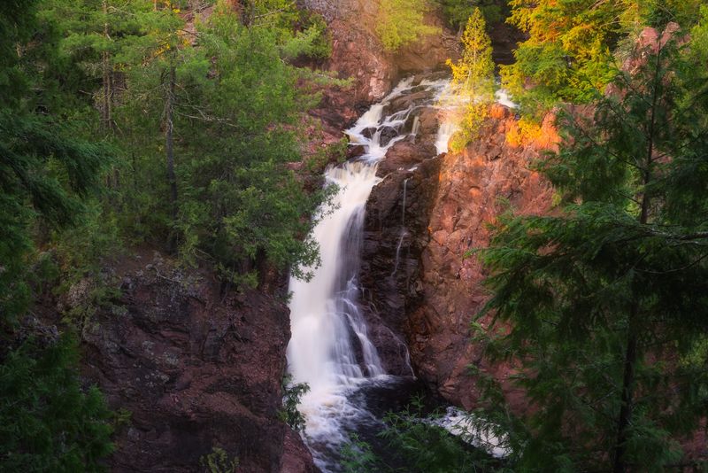 A Cascade Surrounded By Rugged Northwoods Forest