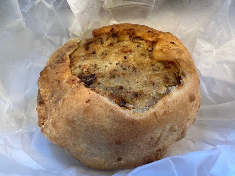 The Legendary Knish: Gargantuan, Golden, And Completely Unapologetic