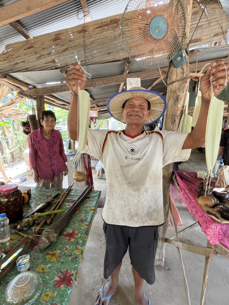 Mr Happy Man holding wind chimes which we will take home