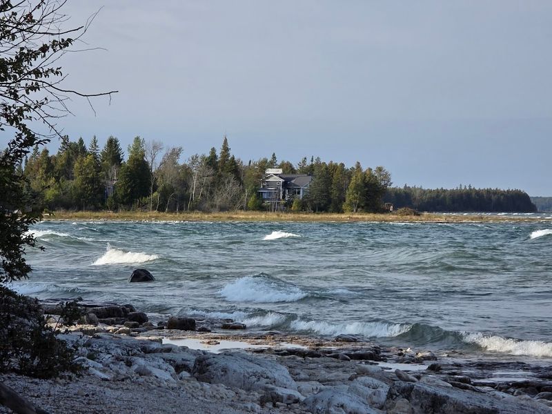 Surrounded By Rocky Shorelines And Clear Water
