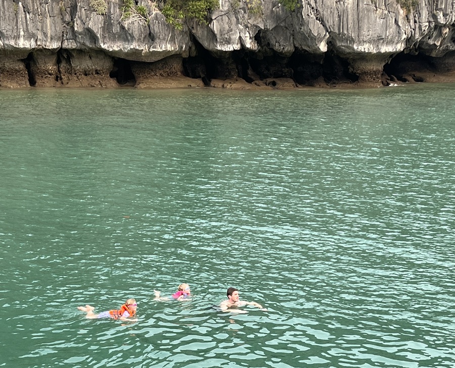 The Malone sisters and their dad swimming in Lan Ha Bay, Vietnam