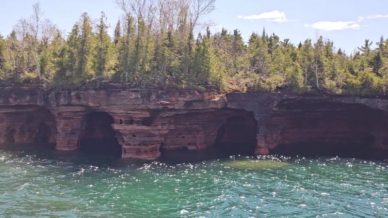Colourful Sandstone Cliffs That Stand Out Against The Water