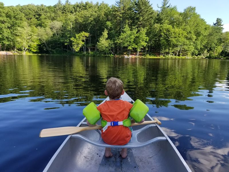Kayaking And Canoeing On Calm, Peaceful Water