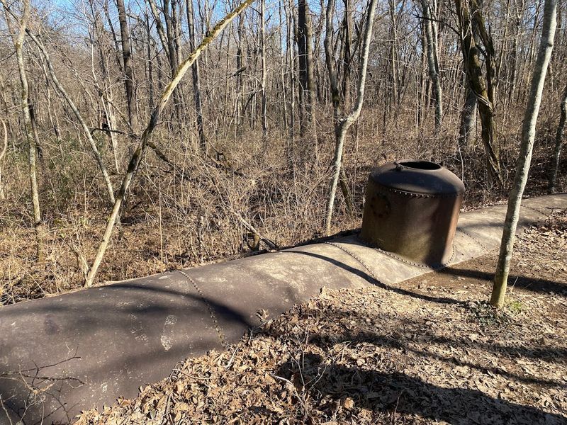 The Abandoned Concrete Structures And A Buried Train Car On The Trail