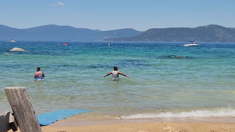 The Beach Has Soft Sand And Clear Shallow Water
