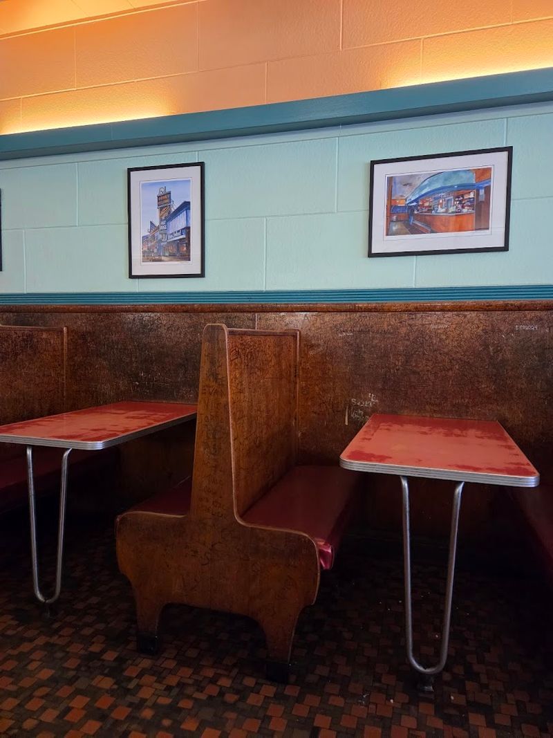 The Historic Wooden Booths Where Visitors Carve Their Names Into History