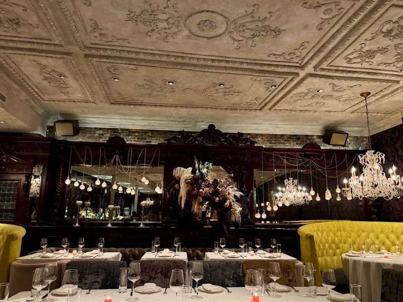 The Main Dining Room With Crystal Chandeliers And Bold Artwork