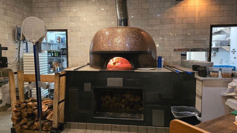 A Wood-Fired Oven Gives The Crust Its Signature Char