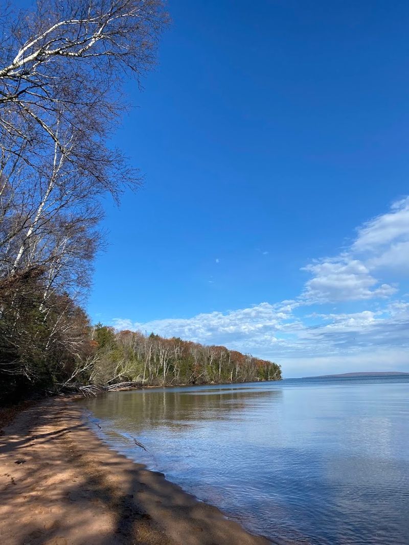 A Quiet Sandy Beach Waits At The End Of The Walk
