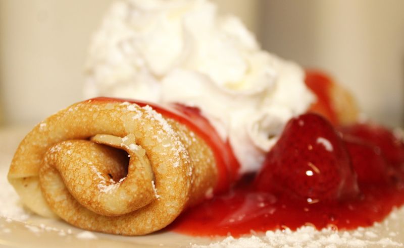 The Rolled Pancakes Arrive Filled And Covered With Sweet Toppings