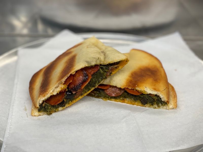 Spinach Cheese Pepperoni And Olives Fill The Famous Specialty