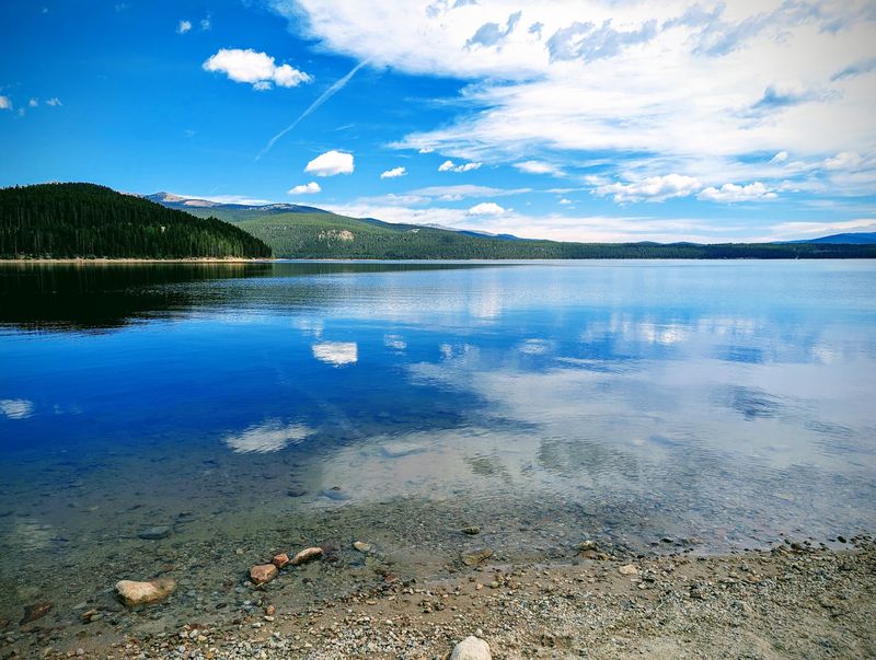 Paddleboards, Kayaks, And Glassy Morning Water
