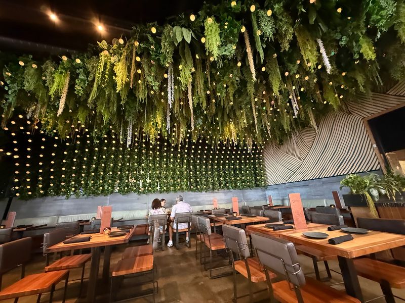 A Dining Room Full Of Greenery And Warm Light