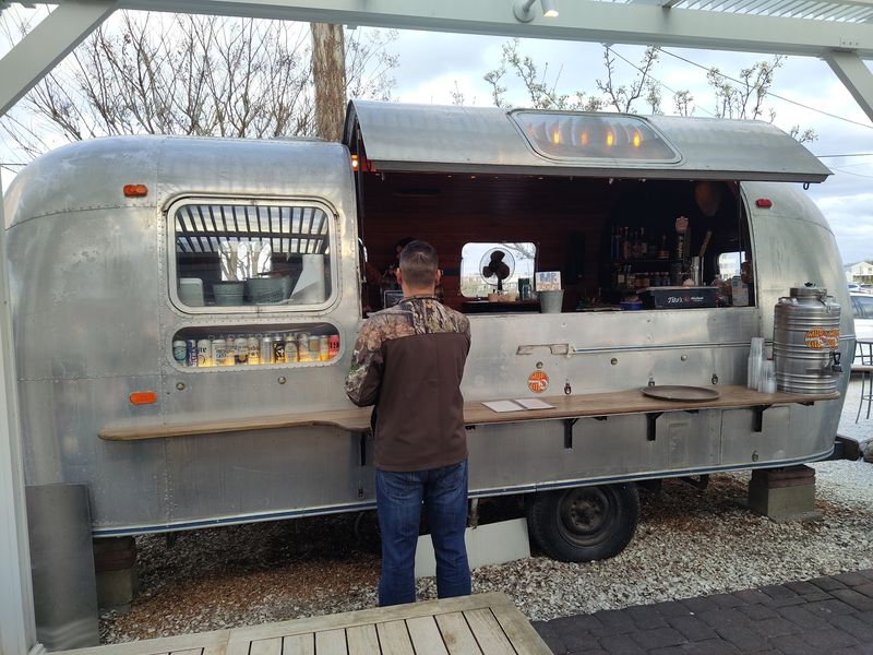 The Patio, The Fire Pit, And A Converted Trailer
