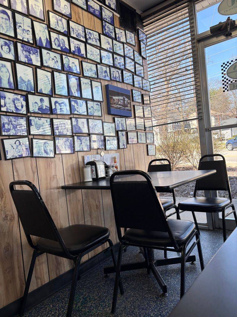 Hundreds Of Framed Faces Watching Over Breakfast