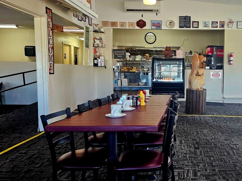 Burgundy Tables And A Wooden Bear
