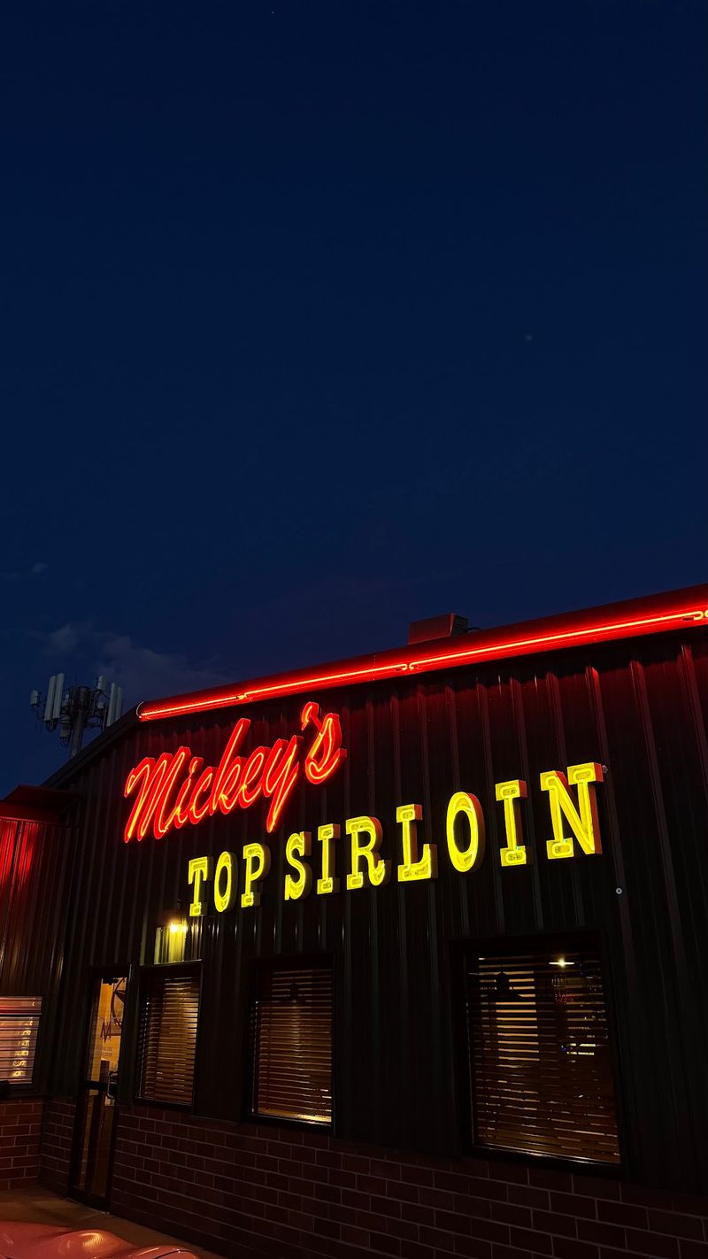 Neon Sign, Green Exterior, And A Bocce Court