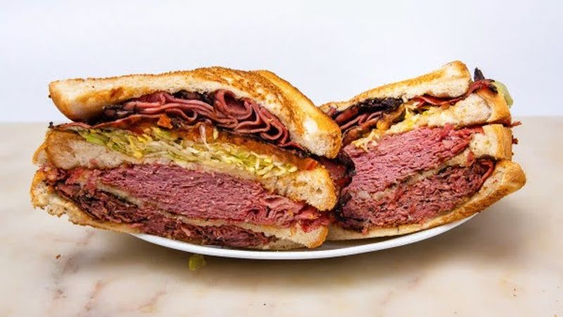 The Corned Beef Arrives Stacked High Enough To Need Both Hands