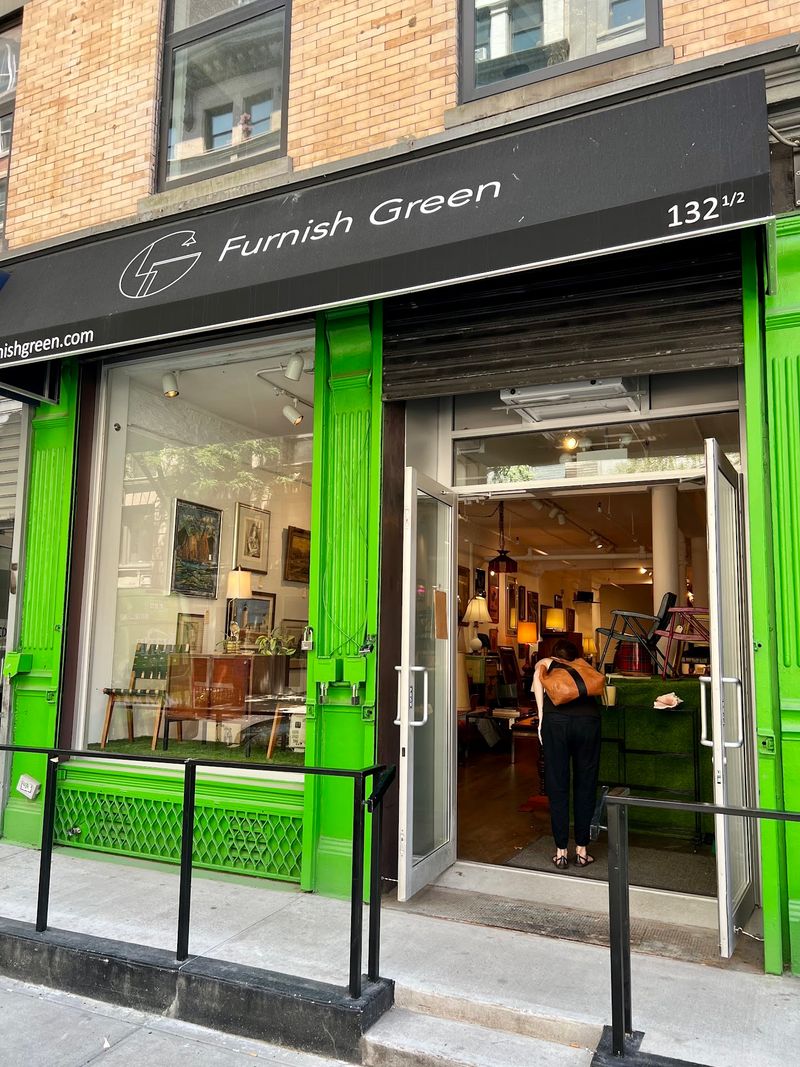 A Green Storefront With A Rotating Cast
