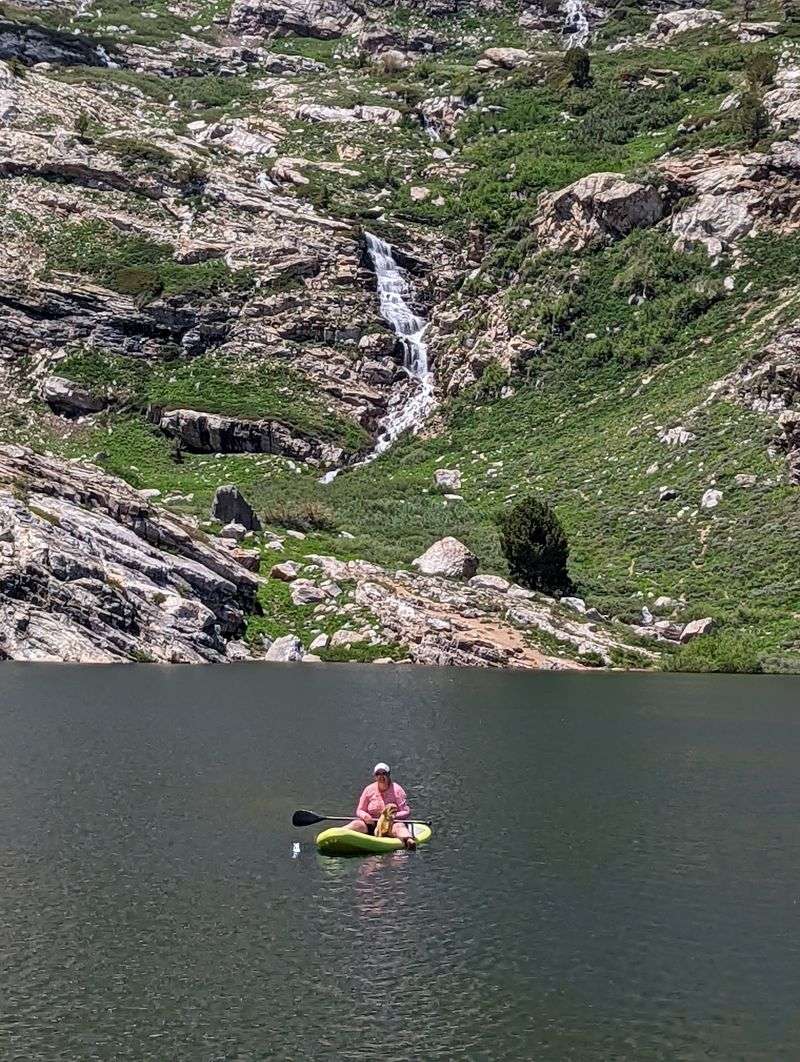 Paddleboarding And Kayaking On Glassy Water
