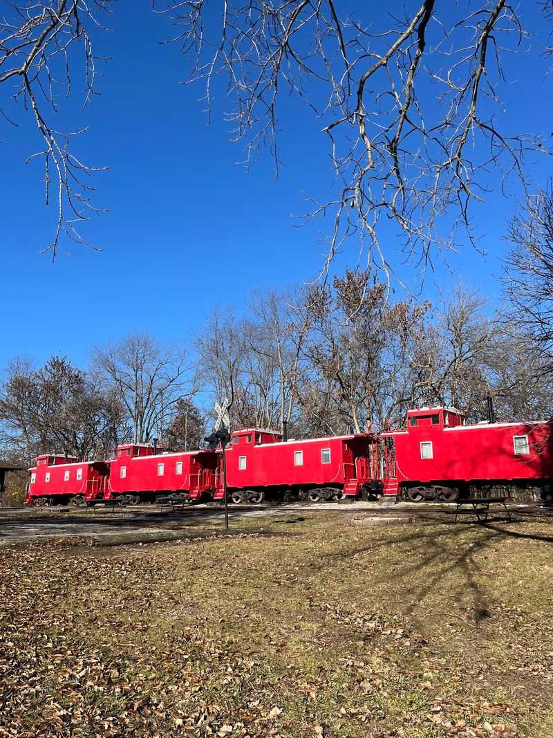 Santa Fe Cabooses Parked Beside a Quiet Lake