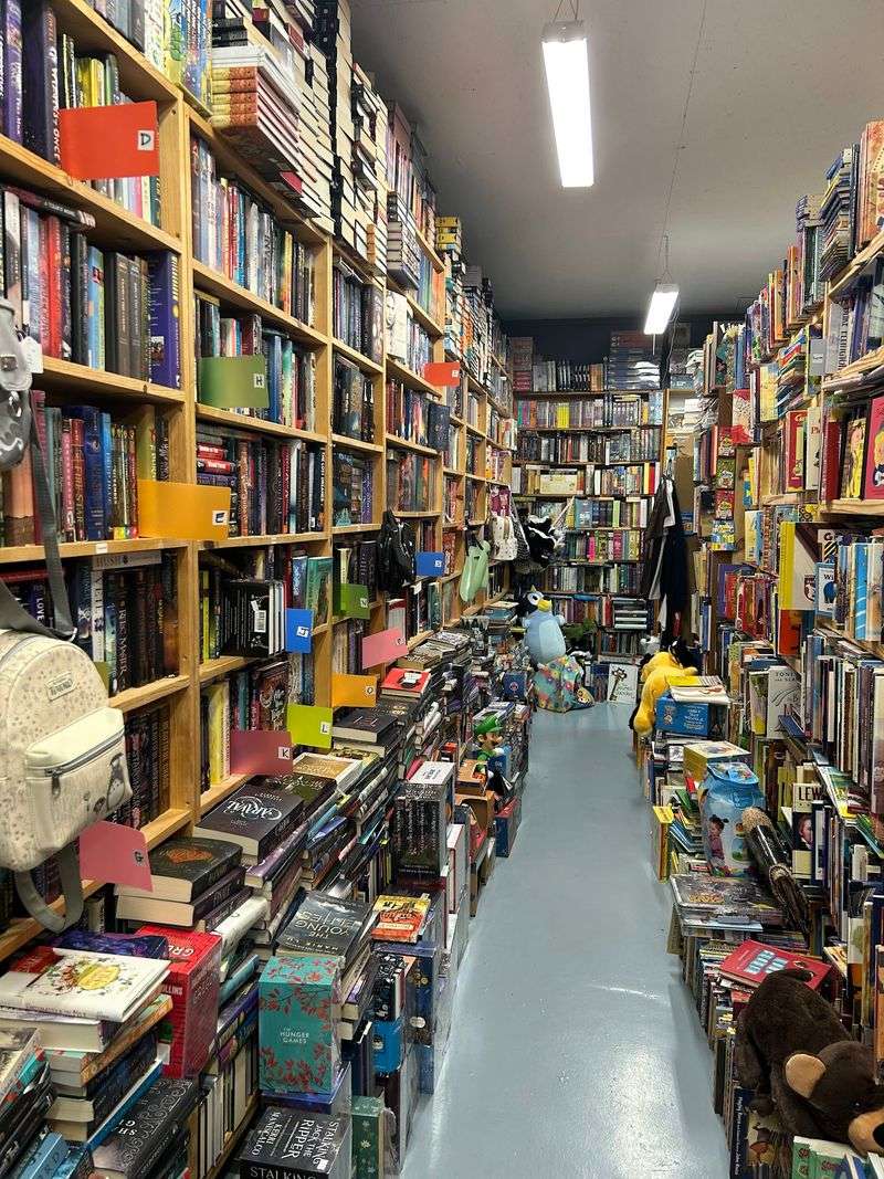 One Hundred Thousand Books Stacked To The Ceiling