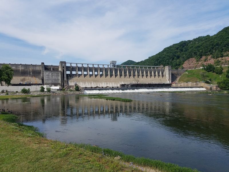 A Giant Dam With A Gentle Lake Behind It