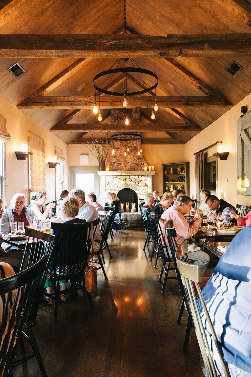 Interiors Designed With Antiques And A Stone Fireplace