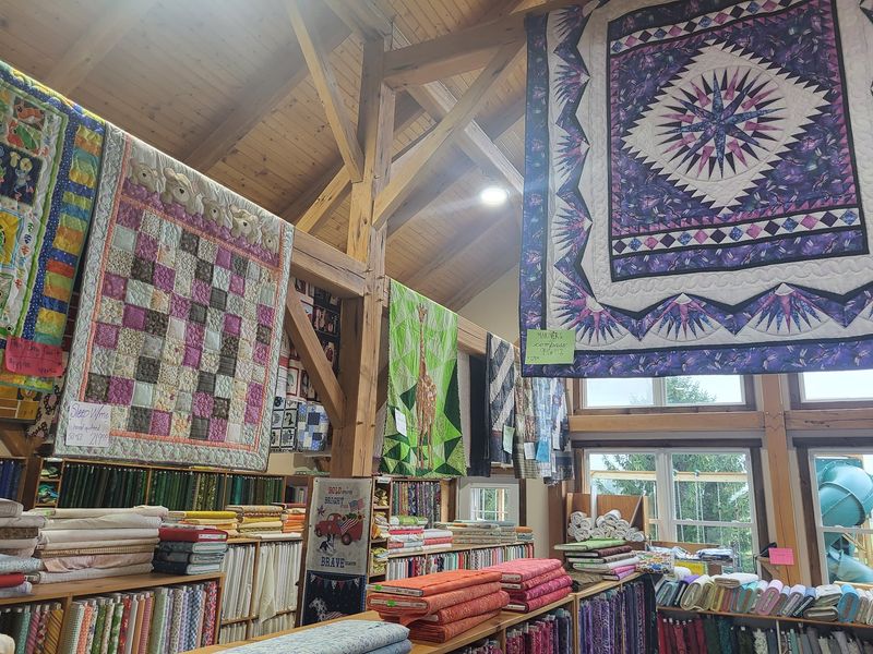 Handmade Amish Quilts Folded Near The Door
