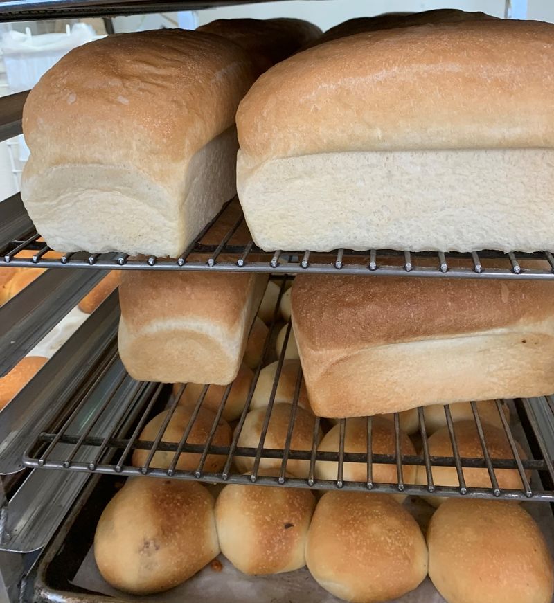 A Bakery Counter Stacked With Homemade Bread