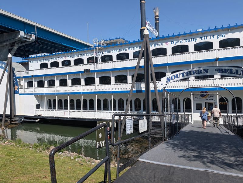 A Riverfront Pier With A Paddlewheel Landmark