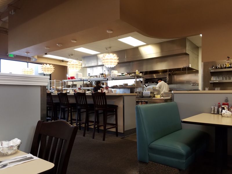 Counter Seats, Booths, And A View Of The Grill