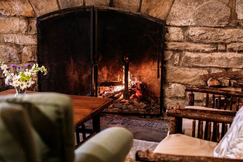 Dinner Gets Fancy Beside A Wood-Burning Stone Fireplace